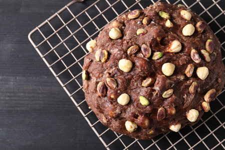 Raw chocolate dough with nuts on black wooden table, top view. Space for textの写真素材