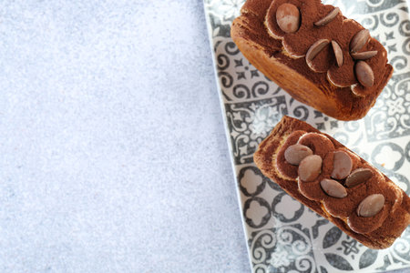 Tasty puff pastry. Supreme croissants with chocolate chips and cream on gray table, top view. Space...