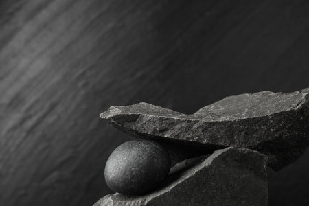 Presentation for product. Podium made of different stones on gray textured background. Space for textの写真素材
