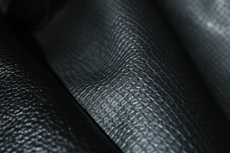 Black natural leather as background, closeup view
