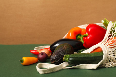 String bag with fresh vegetables on color background, space for textの写真素材