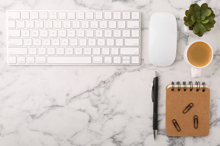 Flat lay composition with different office stationery on white marble table, space for textの写真素材