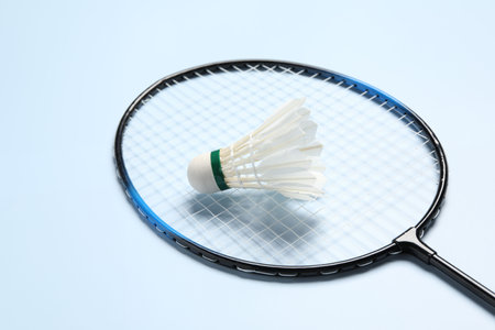 Feather badminton shuttlecock and racket on light blue background, closeupの写真素材