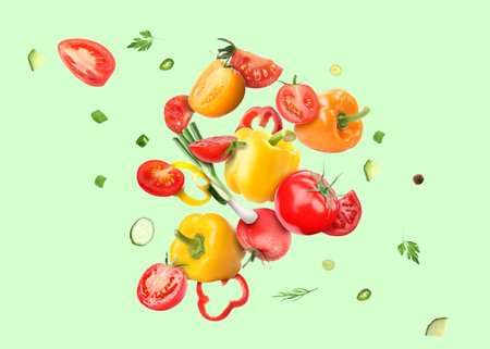 Different fresh vegetables in air on light green backgroundの写真素材