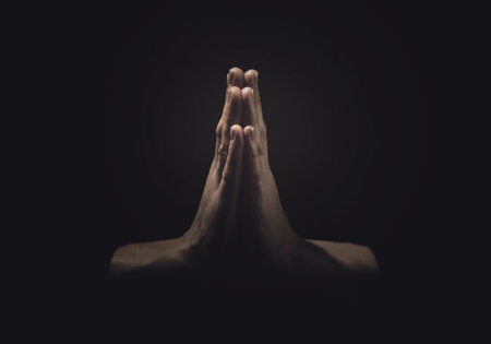 Christian woman praying in darkness, closeup. Beliefの写真素材