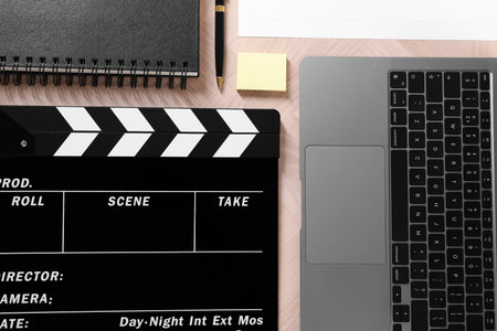 Flat lay composition with movie clapper on wooden tableの写真素材