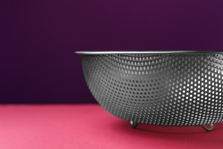 One clean empty colander on color background, , closeup. Space for textの写真素材