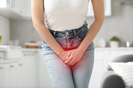Woman suffering from cystitis symptoms indoors, closeup