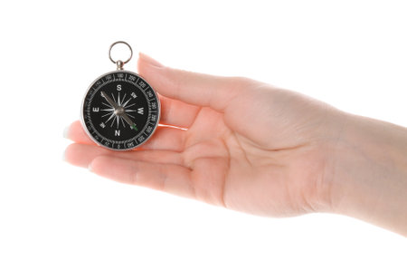 Woman holding compass on white background, closeup. Tourist equipmentの写真素材
