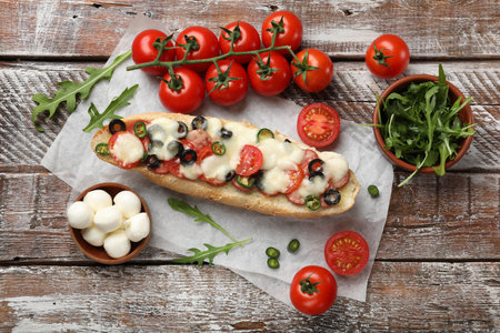 Tasty pizza toast and ingredients on wooden table, top viewの写真素材