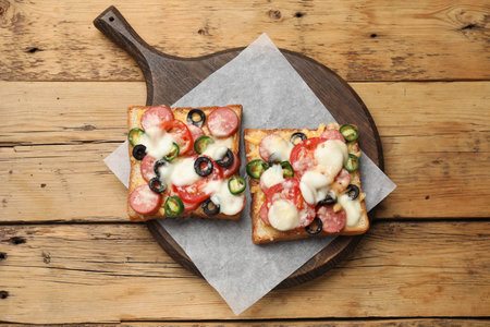 Tasty pizza toasts on wooden table, top viewの写真素材