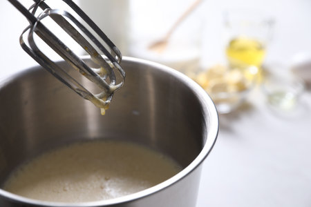 Making dough in bowl of stand mixer on white tableの写真素材