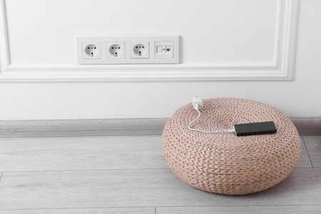 Electric power sockets on white wall indoors