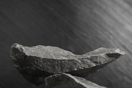 Presentation for product. Podium made of stones on gray textured background. Space for textの写真素材