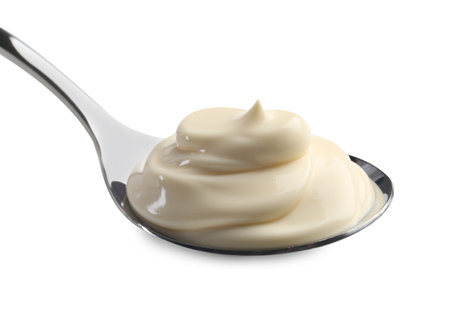 Natural yogurt in spoon isolated on whiteの写真素材