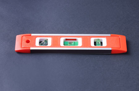 Building level on dark background. Construction tool