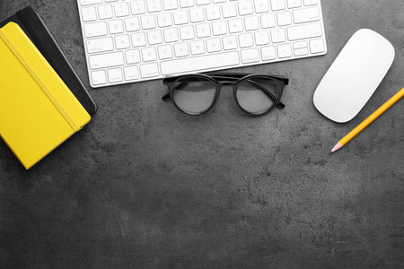 Flat lay composition with different office stationery on dark gray table, space for text