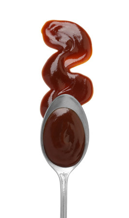 Tasty barbecue sauce and spoon isolated on white, top viewの写真素材