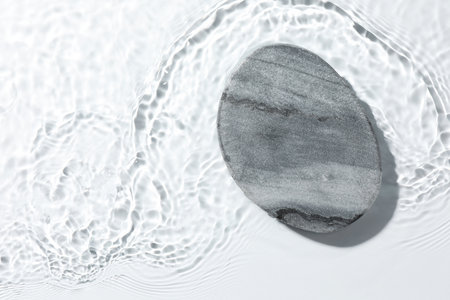 Presentation of product. Stone podium in water on white background, top view. Space for textの写真素材