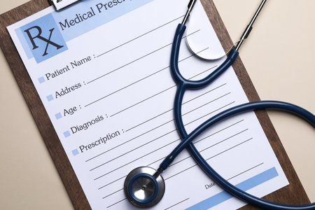 Clipboard with medical prescription form and stethoscope on beige background, flat layの写真素材