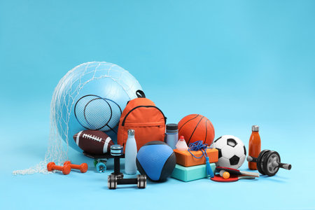 Many different sports equipment on light blue backgroundの写真素材