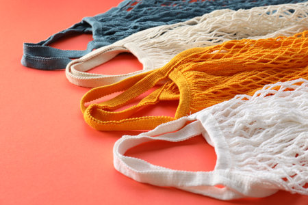 Different string bags on red background, closeup
