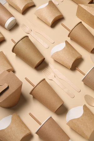 Eco friendly food packaging. Paper containers and wooden cutlery on beige background, above viewの写真素材