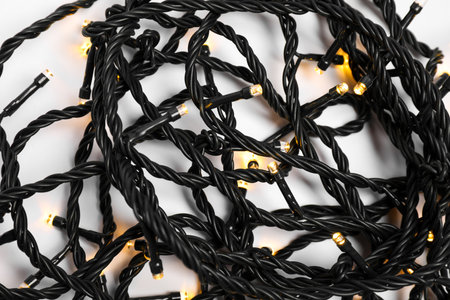 Beautiful Christmas lights on white background, closeup