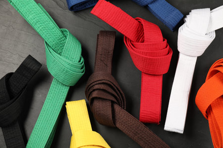 Colorful karate belts on gray background, flat layの写真素材