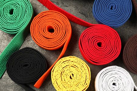Colorful karate belts on gray background, flat layの写真素材