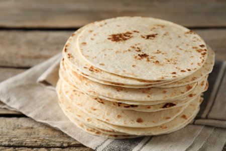 Stack of tasty homemade tortillas on wooden table, closeupの写真素材