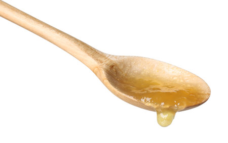 Spoon with tasty sweet jam isolated on whiteの写真素材