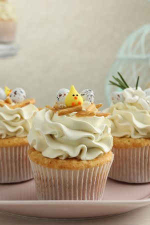 Tasty Easter cupcakes with vanilla cream on tableの写真素材