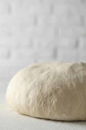 Fresh raw homemade dough on light table