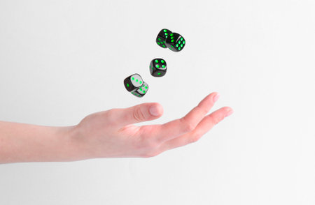 Woman throwing game dices on white background, closeupの写真素材