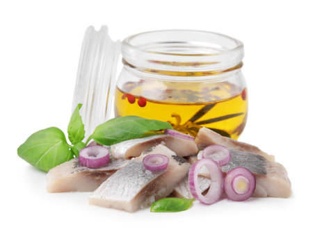 Pieces of tasty fish, onion, basil and marinade isolated on whiteの写真素材
