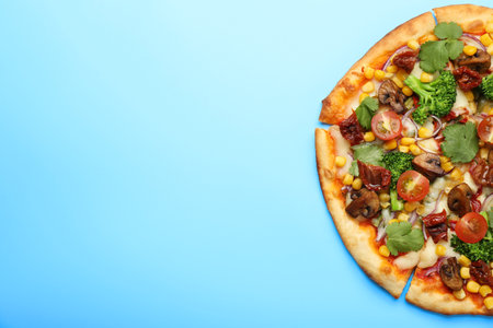 Delicious vegetarian pizza with mushrooms, vegetables and parsley on light blue background, top view. Space for textの写真素材