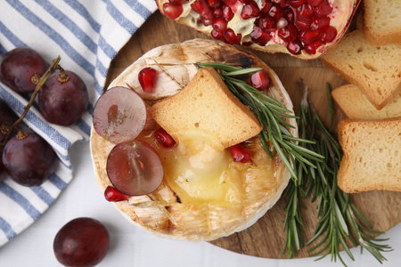 Flat lay composition with tasty baked camembert on white tiled tableの写真素材