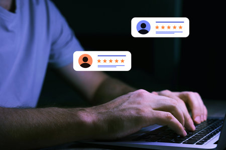 Man leaving feedback using laptop, closeup. Illustrations of reviews with avatars and starsの写真素材