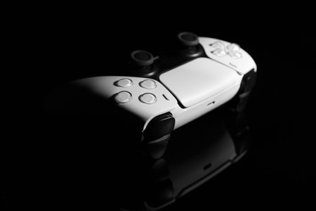 Wireless game controller on black mirror surfaceの写真素材