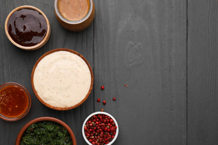 Different fresh marinades on gray wooden table, flat lay. Space for text