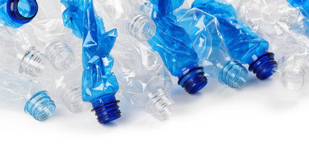 Crumpled disposable plastic bottles on white background, space for text