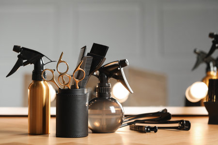 Set of hairdresser tools on table in salon, space for textの写真素材
