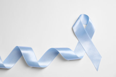 International Psoriasis Day. Light blue ribbon as symbol of support on white background, top viewの写真素材