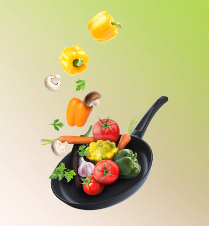 Frying pan and different vegetables in air on color gradient backgroundの写真素材