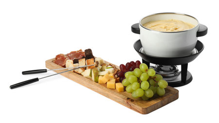 Fondue with tasty melted cheese, forks and different snacks isolated on whiteの写真素材