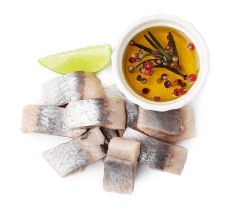 Pieces of tasty fish, lime and marinade isolated on white, top viewの写真素材
