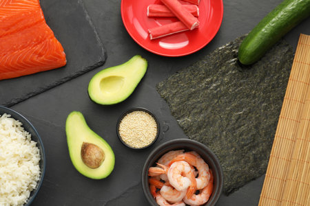 Flat lay composition with ingredients for sushi on dark textured tableの写真素材
