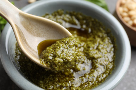 Taking tasty pesto sauce at table, closeupの写真素材