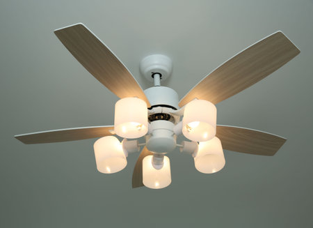 Ceiling fan with lamps indoors, low angle view